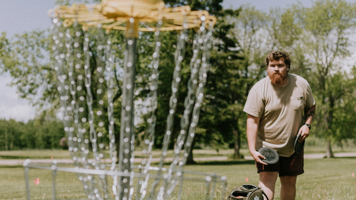 a person standing next to a bird feeder