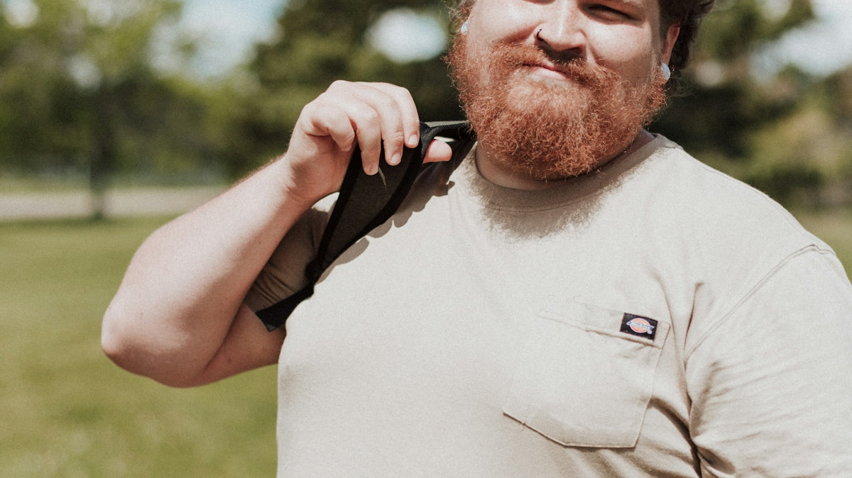 a man with a beard holding a gun