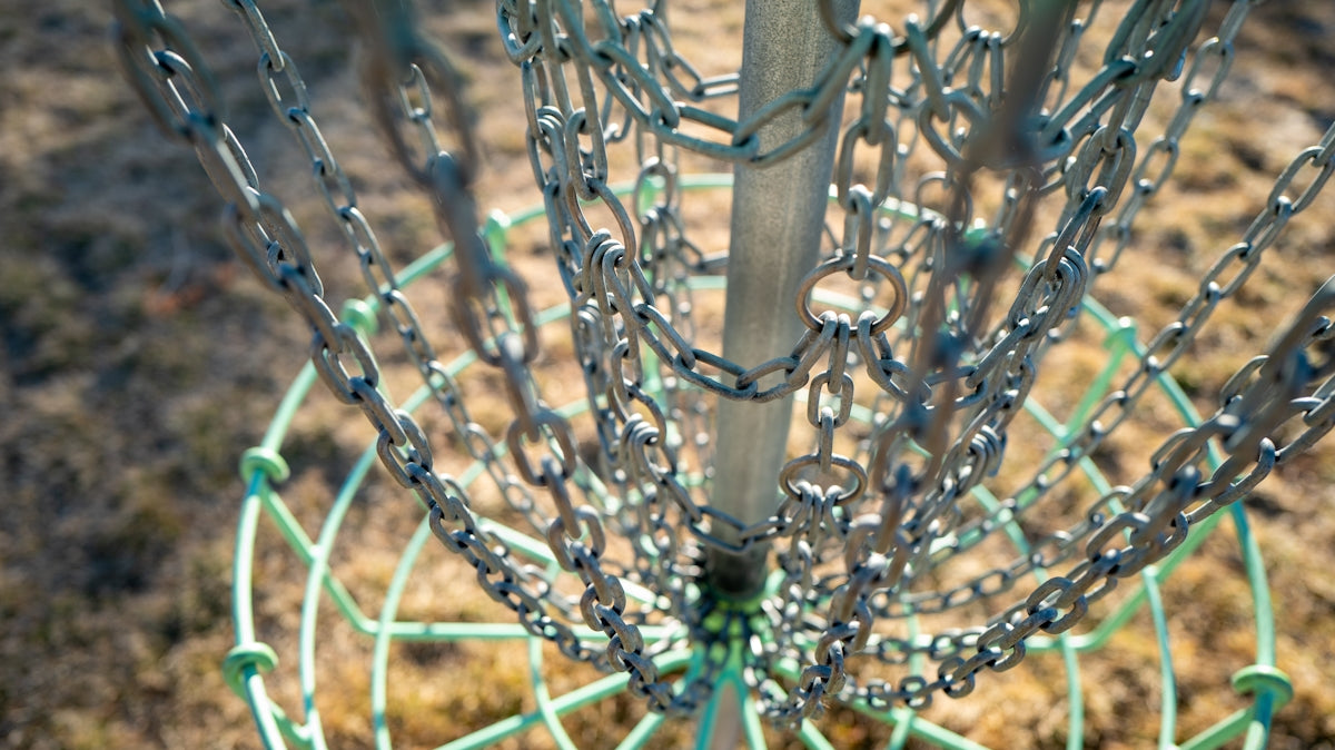 a close up of a metal object with chains on it