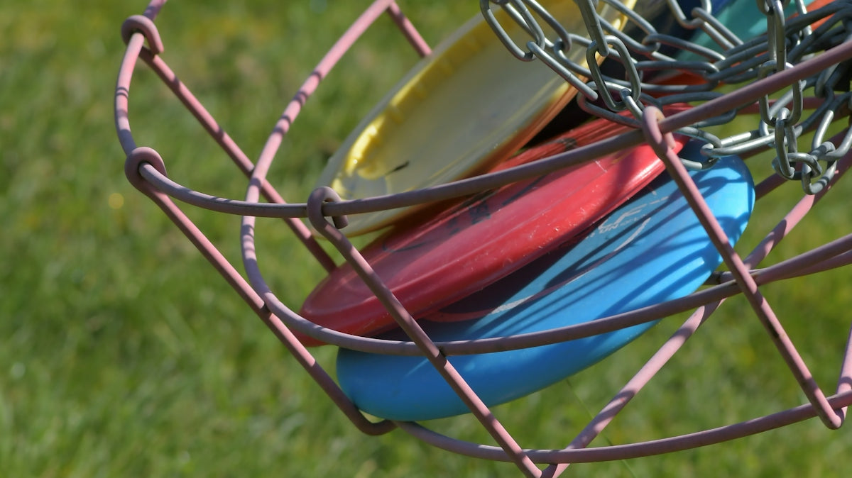 A bunch of frisbees that are in a basket