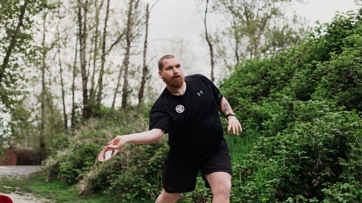 Man throwing a disc in a park