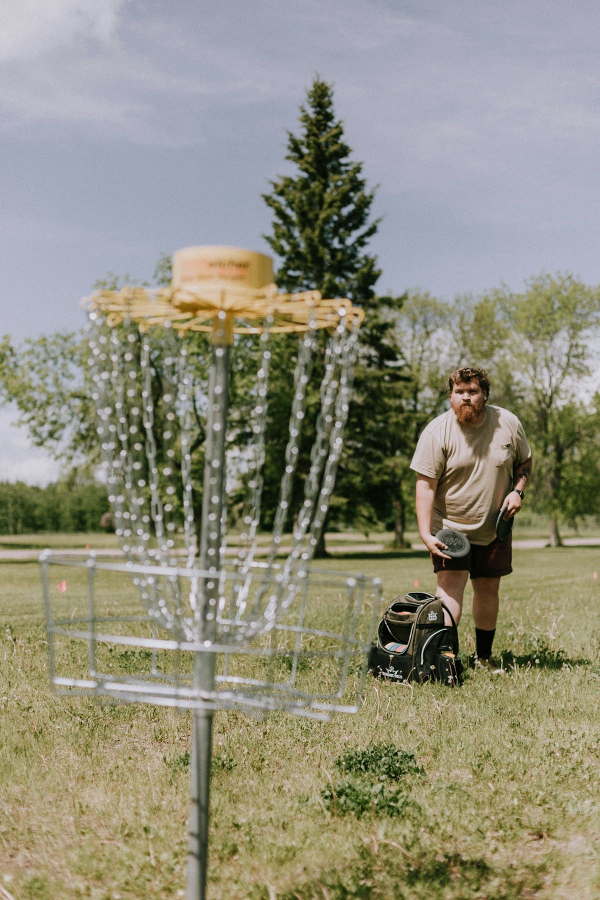 a person standing next to a bird feeder