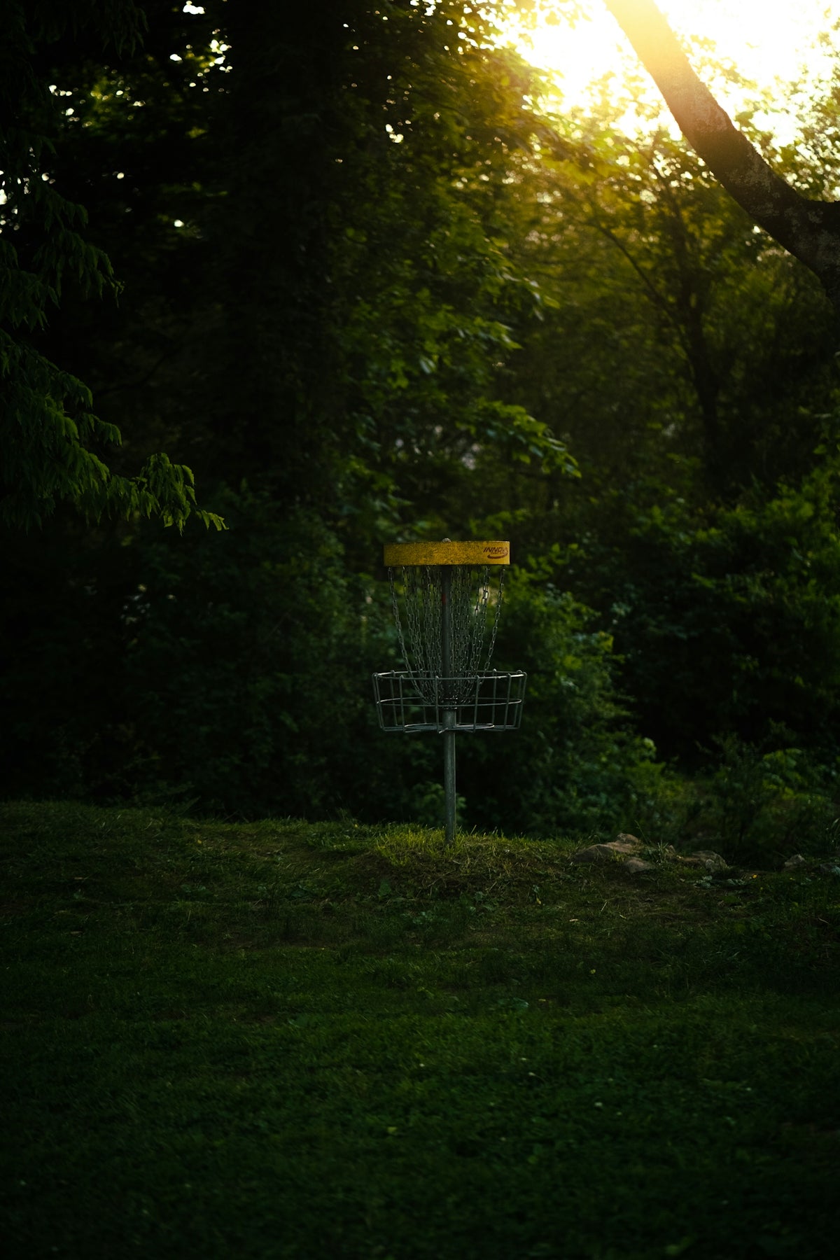 a frisbee golf goal in the middle of a field