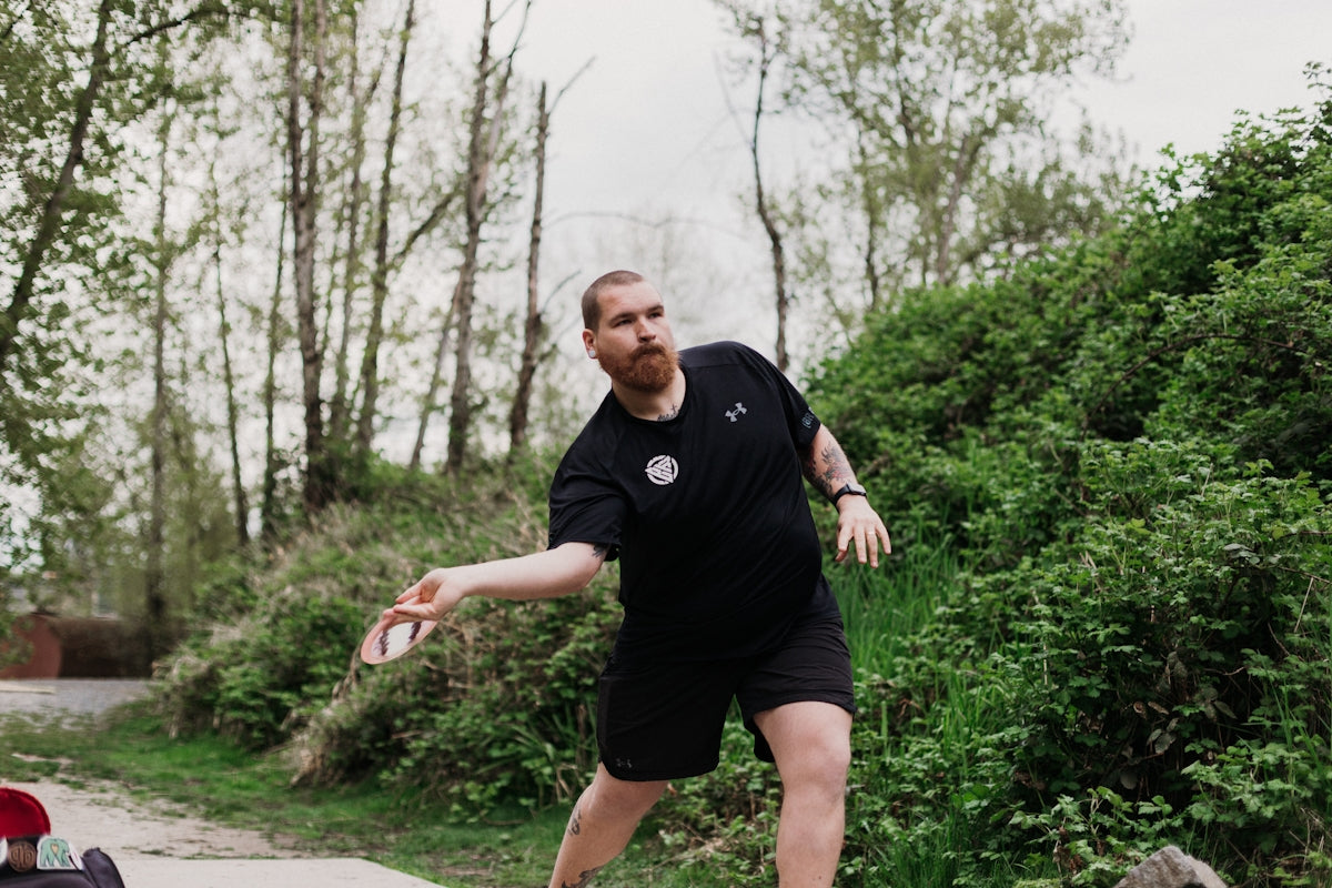 Man throwing a disc in a park